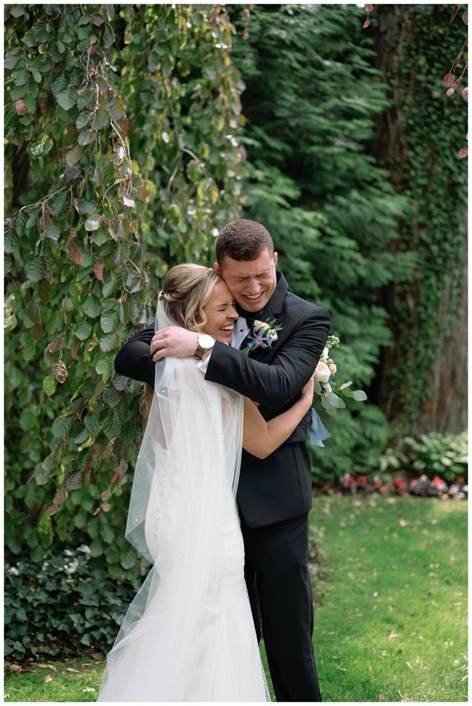 bride and groom hugging with happy tears during first look