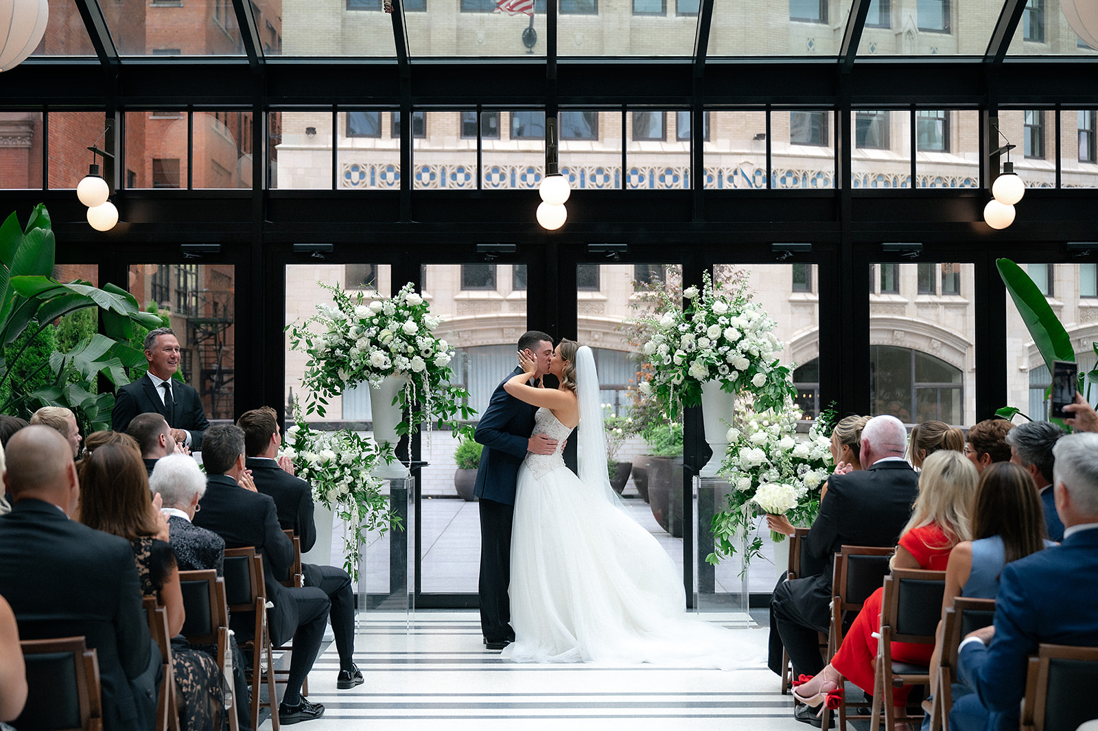 Bride and groom kissing during their Shinola Hotel wedding ceremony in The Birdy Room