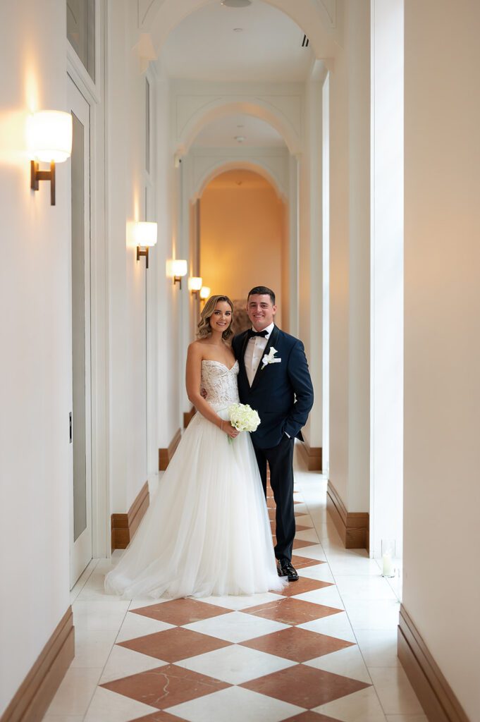 Bride and groom posing in the hallways for their Shinola Hotel wedding portraits in Detroit, Michigan