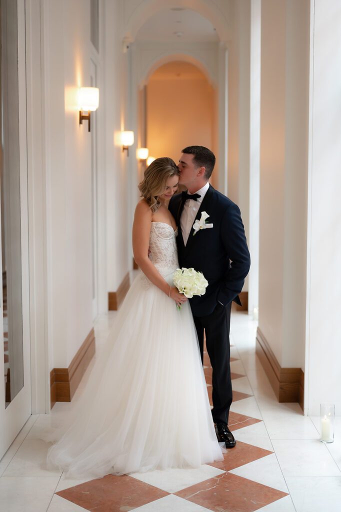 Bride and groom posing in the hallways for their Shinola Hotel wedding portraits in Detroit, Michigan