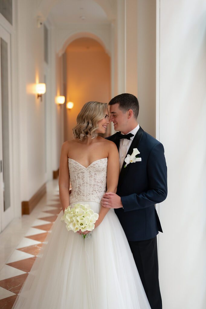 Bride and groom posing in the hallways for their Shinola Hotel wedding portraits in Detroit, Michigan