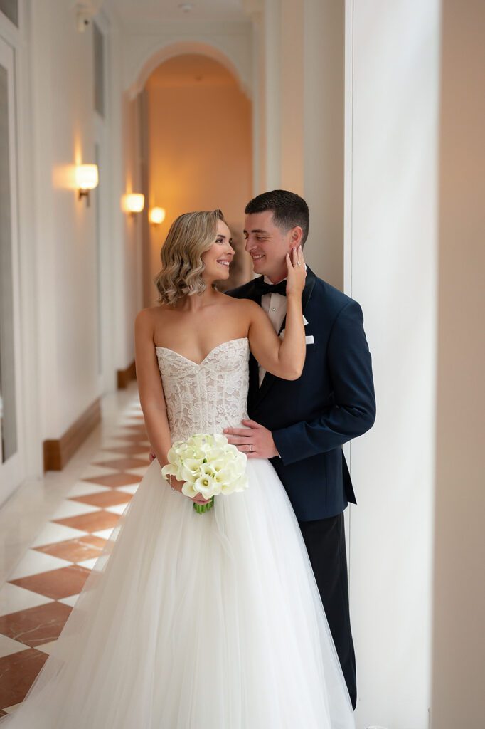 Bride and groom posing in the hallways for their Shinola Hotel wedding portraits in Detroit, Michigan