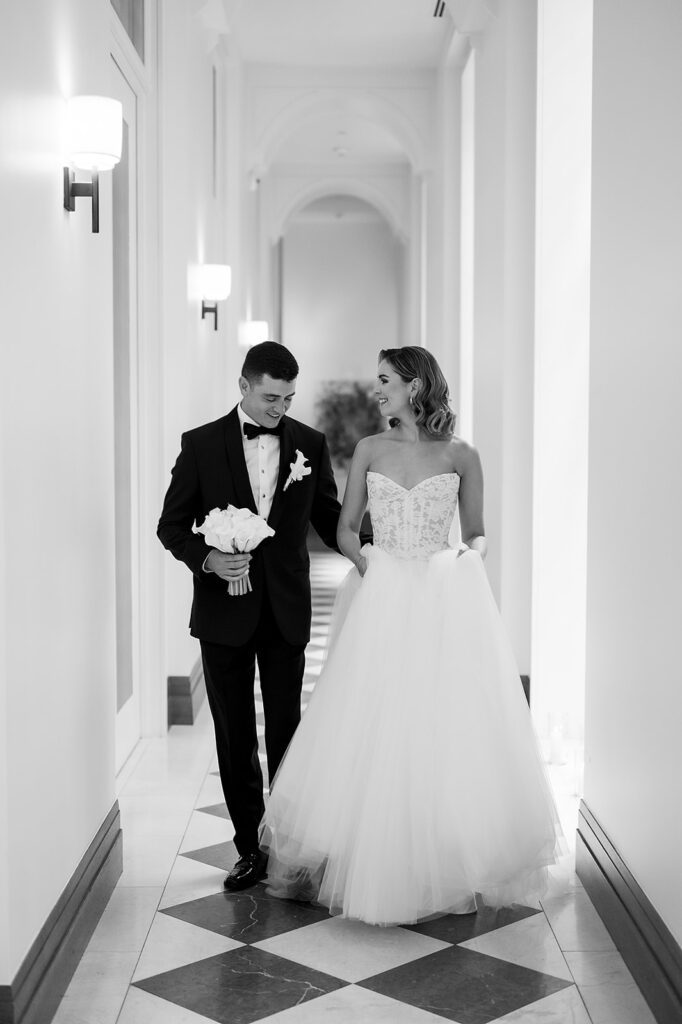 Bride and groom posing in the hallways for their Shinola Hotel wedding portraits in Detroit, Michigan