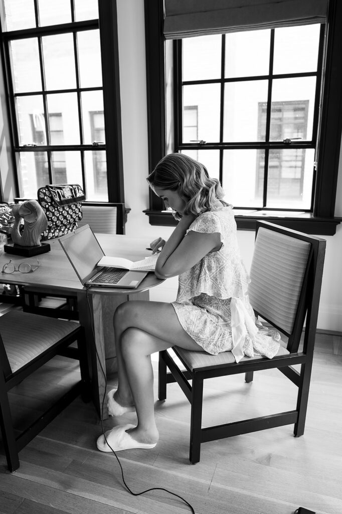 Black and white photo of a bride writing her vows