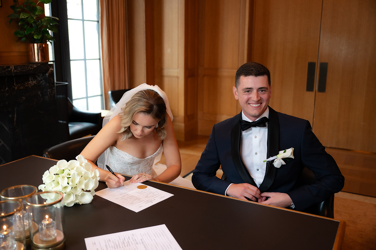 Bride and groom signing their marriage license