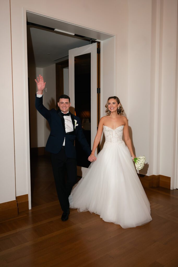 Bride and groom entering their wedding reception