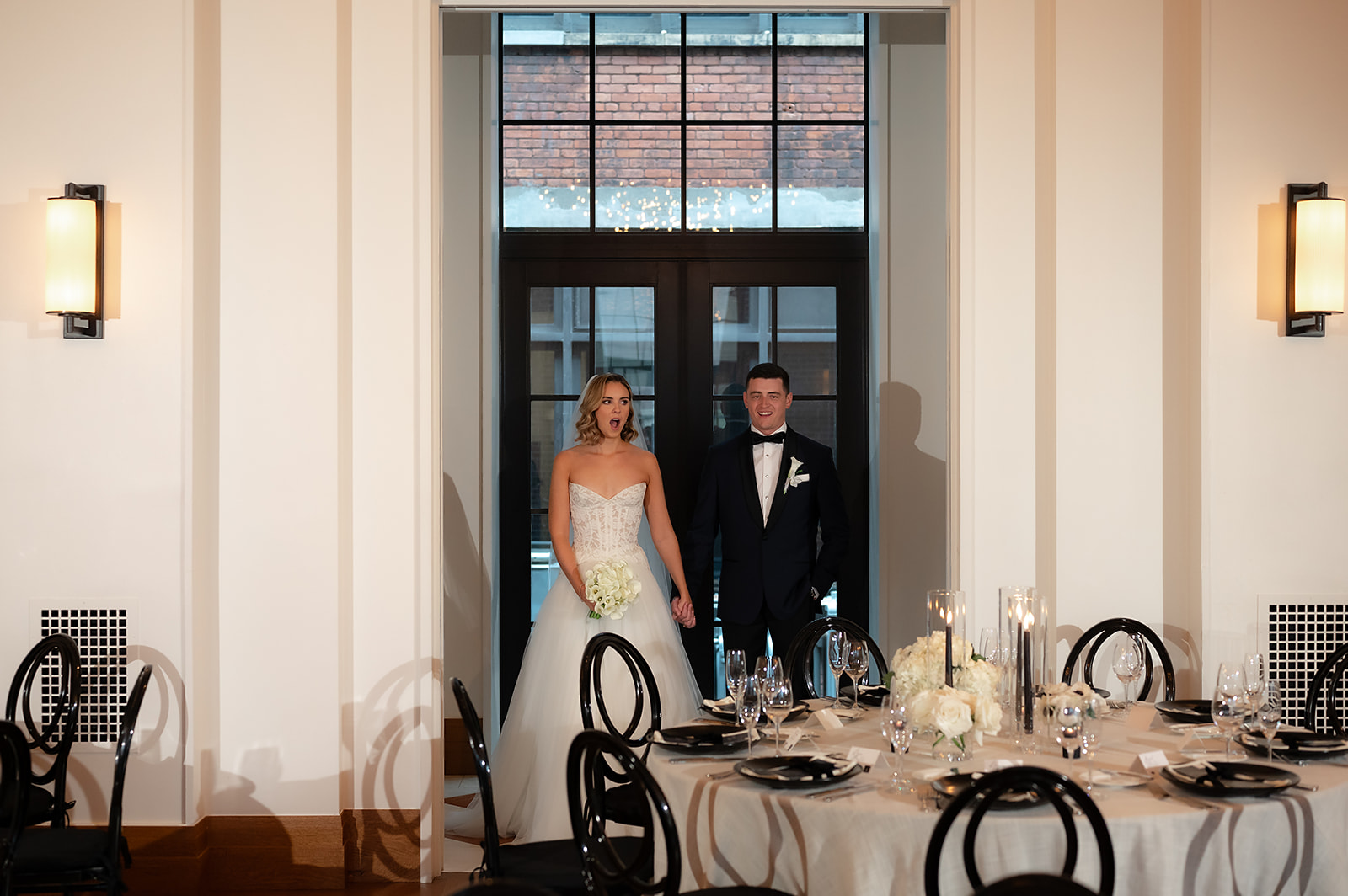 Bride and groom admiring their Shinola Hotel wedding reception space in Bixby Hall