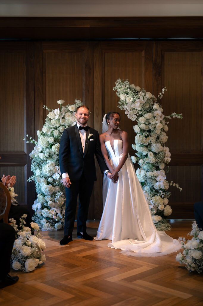 Bride and groom standing at the altar during their Book Tower wedding in The Linden Room