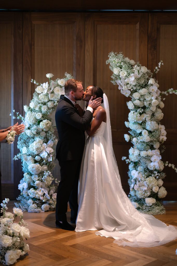 Bride and groom kissing during their ceremony