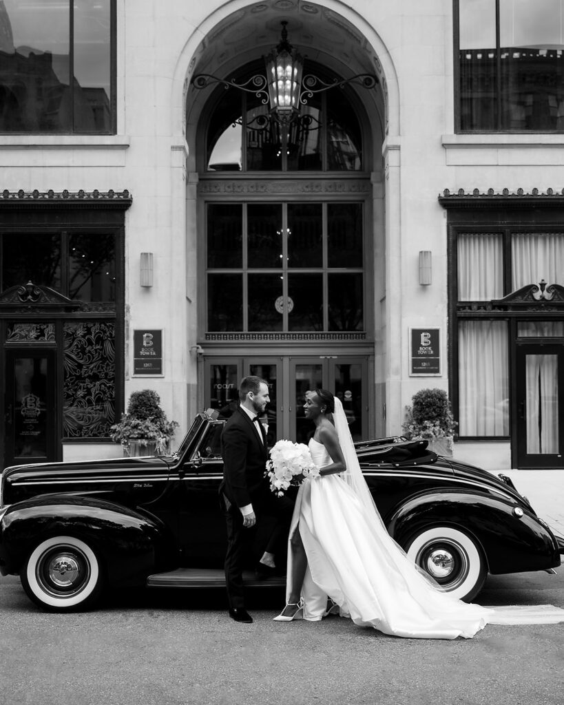 Bride and grooms Book Tower wedding portraits with a 1940 Ford Deluxe convertible from Motor City Vintage Rentals.
