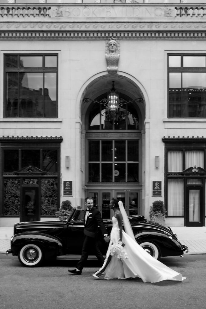 Bride and grooms Book Tower wedding portraits with a 1940 Ford Deluxe convertible from Motor City Vintage Rentals.