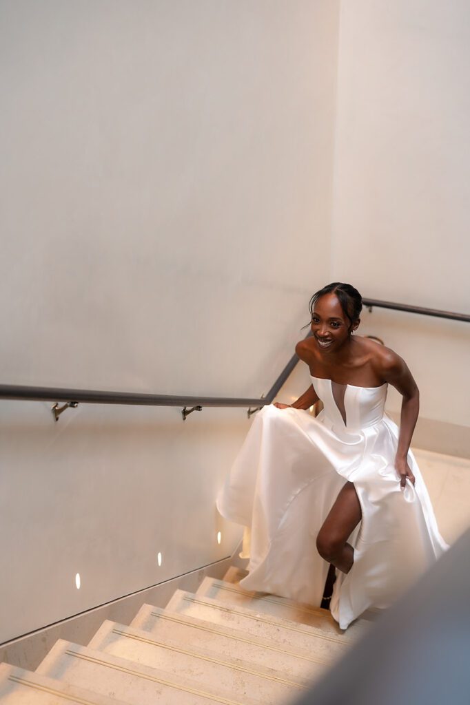 Bride walking up the stairs to have a first look with her groom