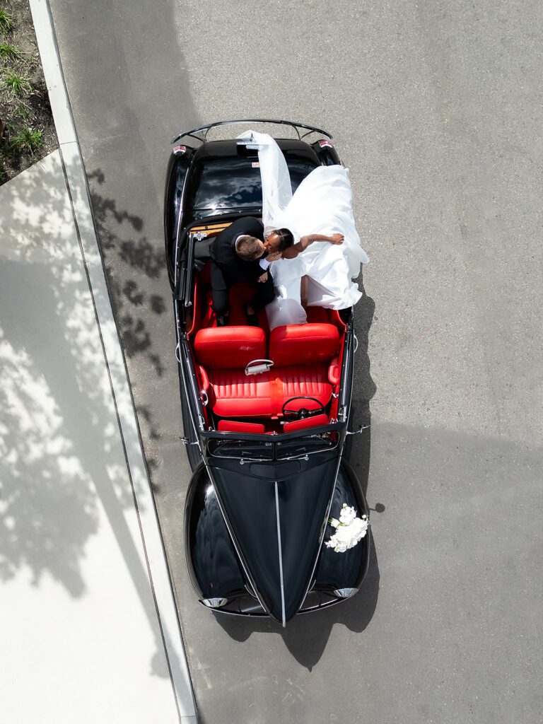 Overhead shots of a bride and groom in a vintage car during their Detroit wedding portraits