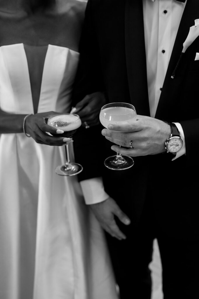 Bride and groom holding their drinks