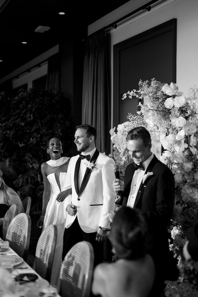Bride and groom laughing during speeches