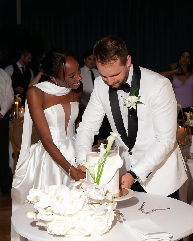 Bride and groom cutting into their wedding cake