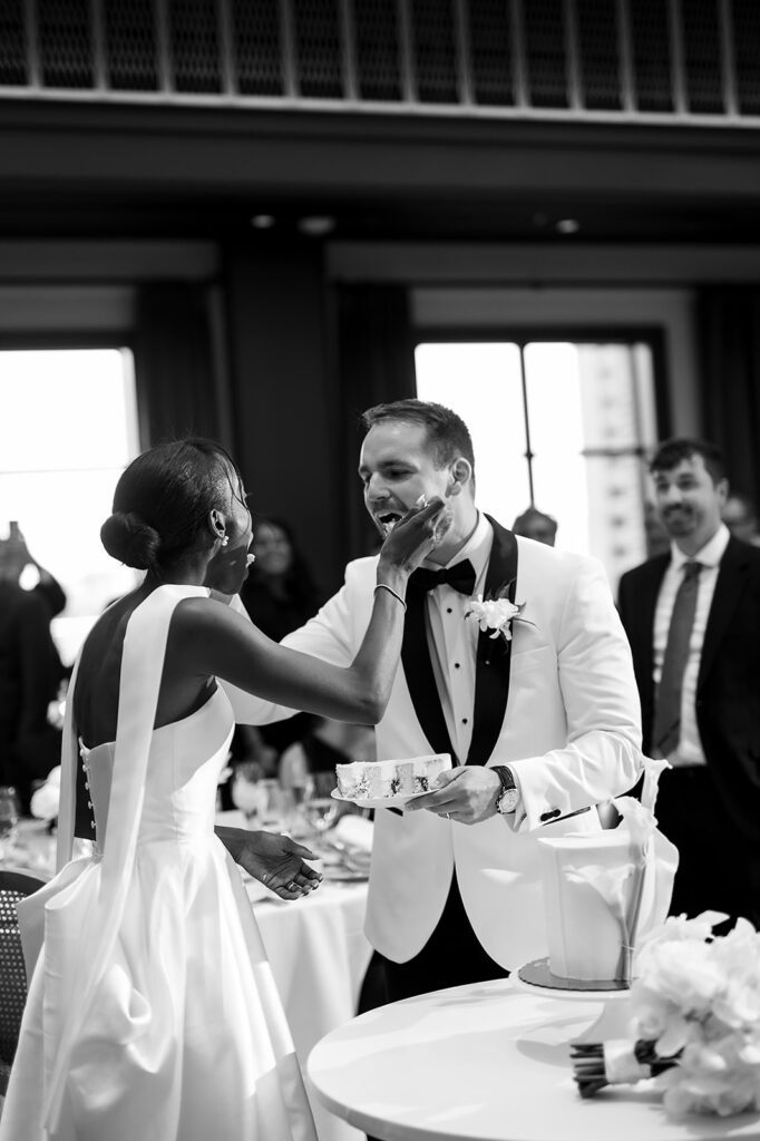 Bride and groom feeding each other their wedding cake