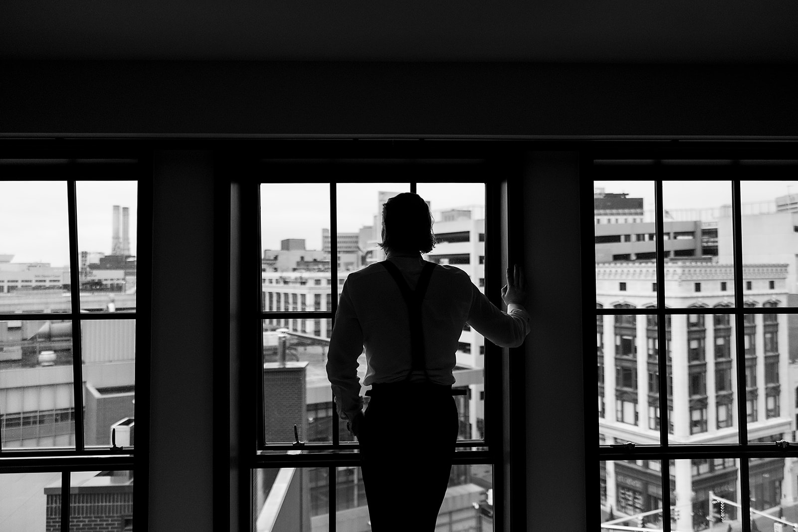Groom admiring the views of Detroit from Shinola Hotel