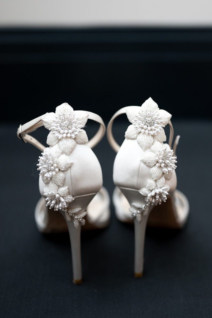Wedding detail shot of a brides floral white heels