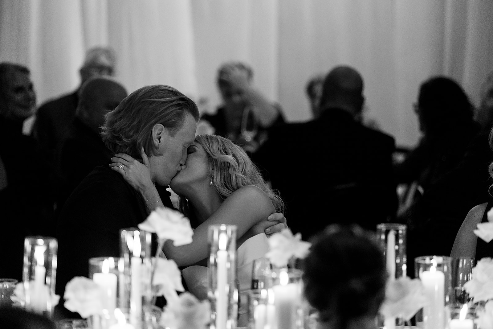 Bride and groom kissing during their reception