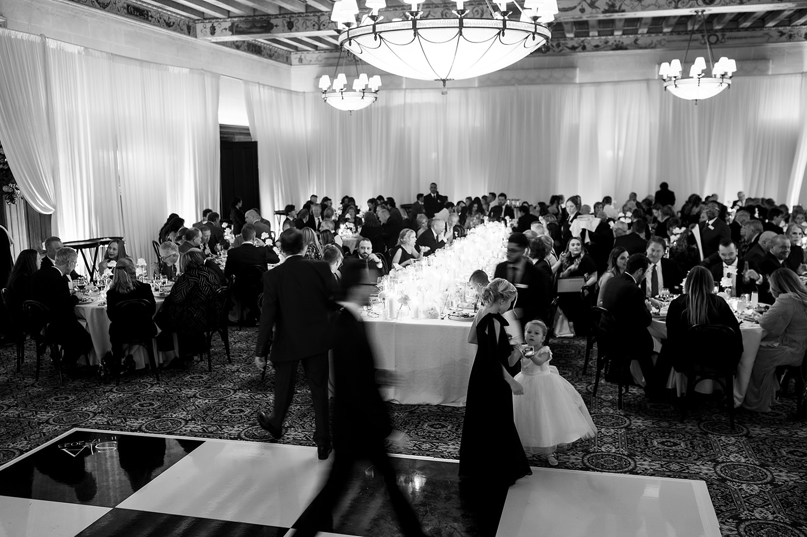 Candid wedding reception photo of a guests walking around
