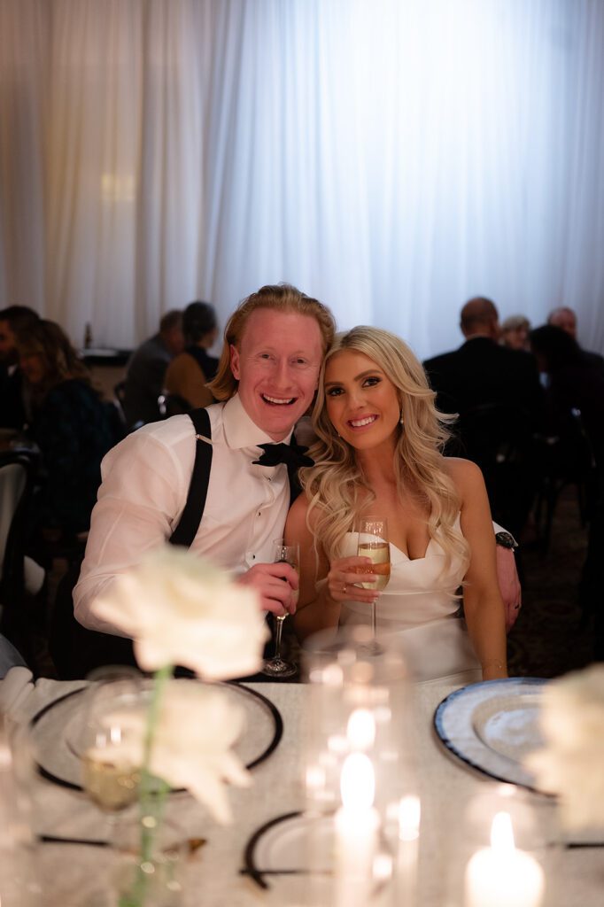 Bride and groom sitting at a reception table together