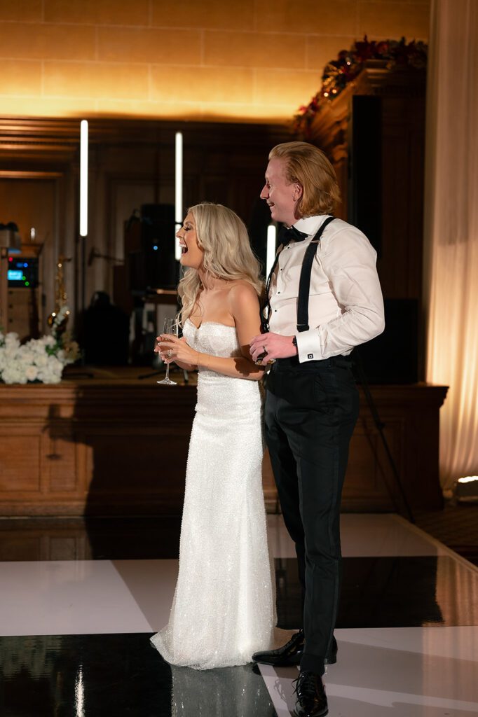 Bride and groom laughing during speeches