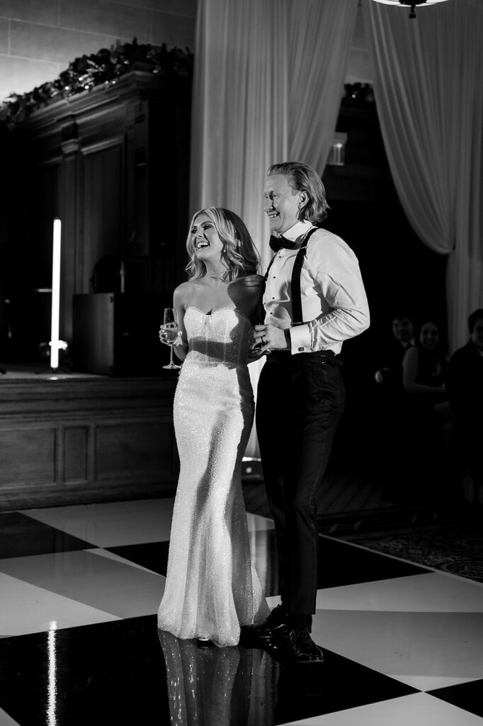Bride and groom smiling during speeches