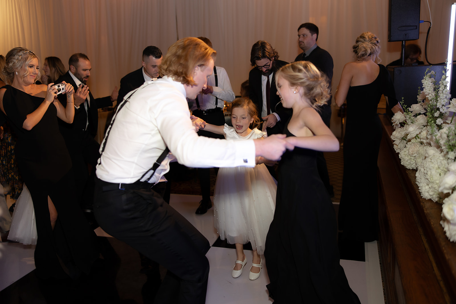 Groom dancing with guests