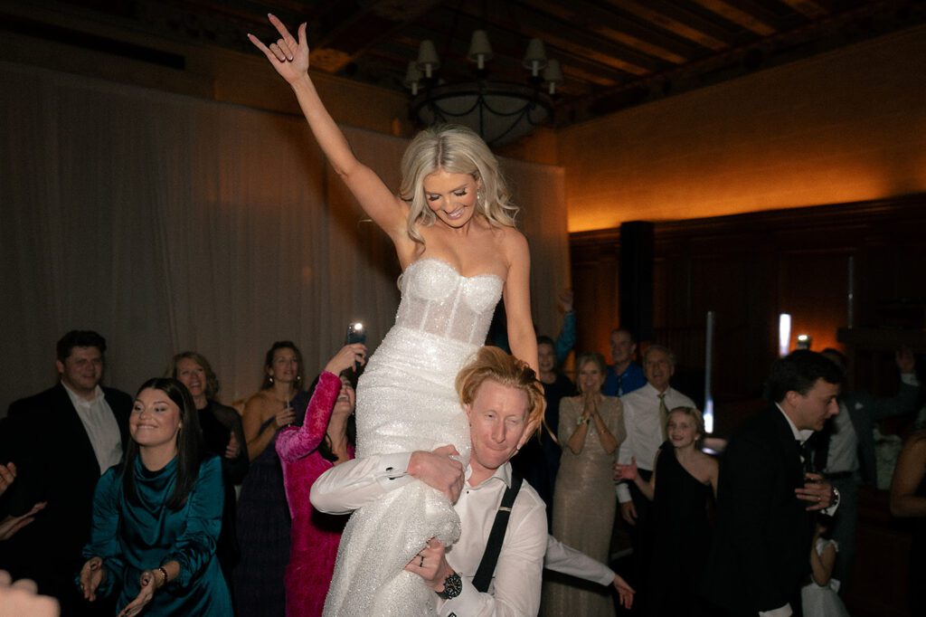 Groom lifting up his bride during the reception