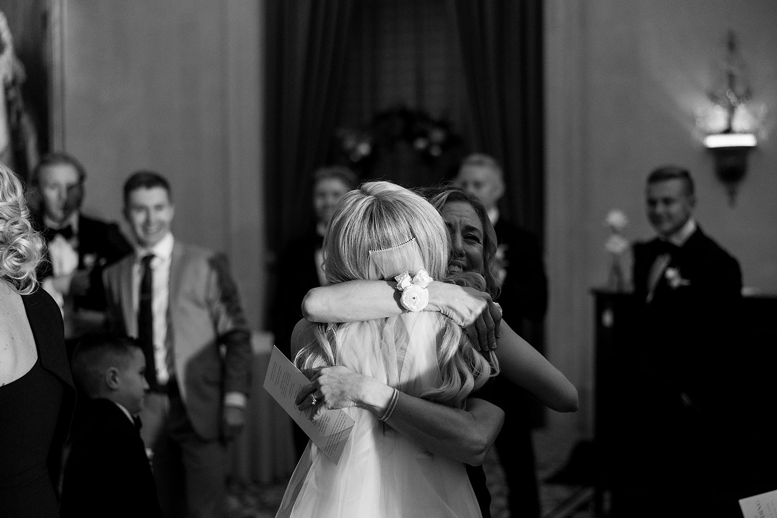 Bride hugging guests during cocktail hour