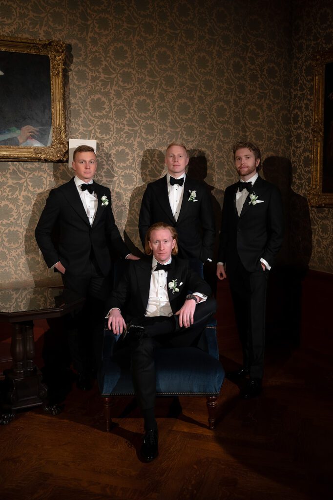 Groom and groomsmen posing at Detroit Athletic Club