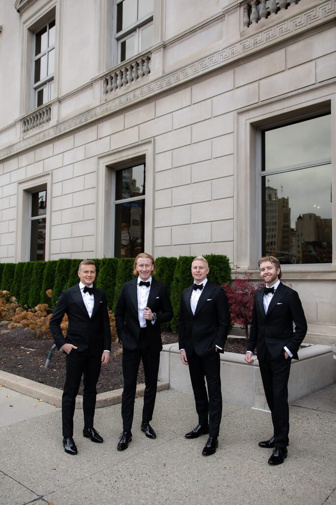 Groom and his groomsmen posing outside of Detroit Athletic Club