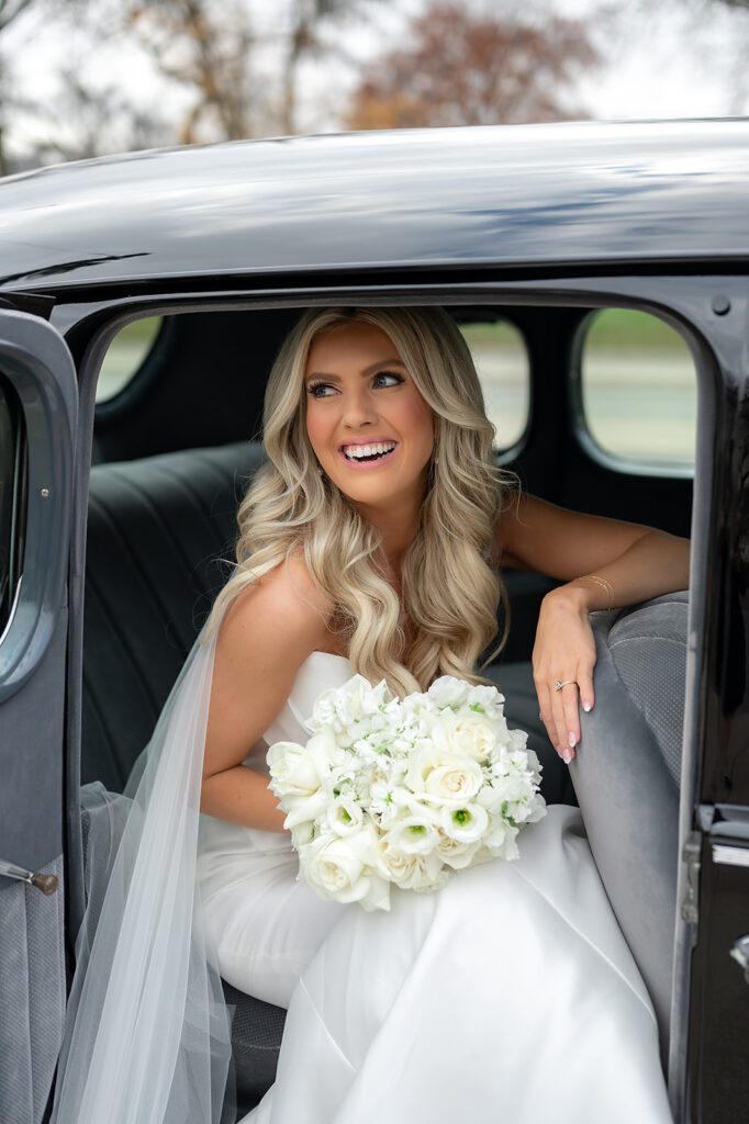 Bride posing with a 1940 Detroit Packard