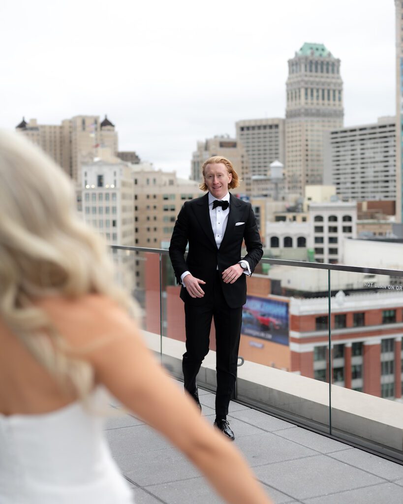 Bride and groom sharing a first look on the rooftop bar at Detroit Athletic Club