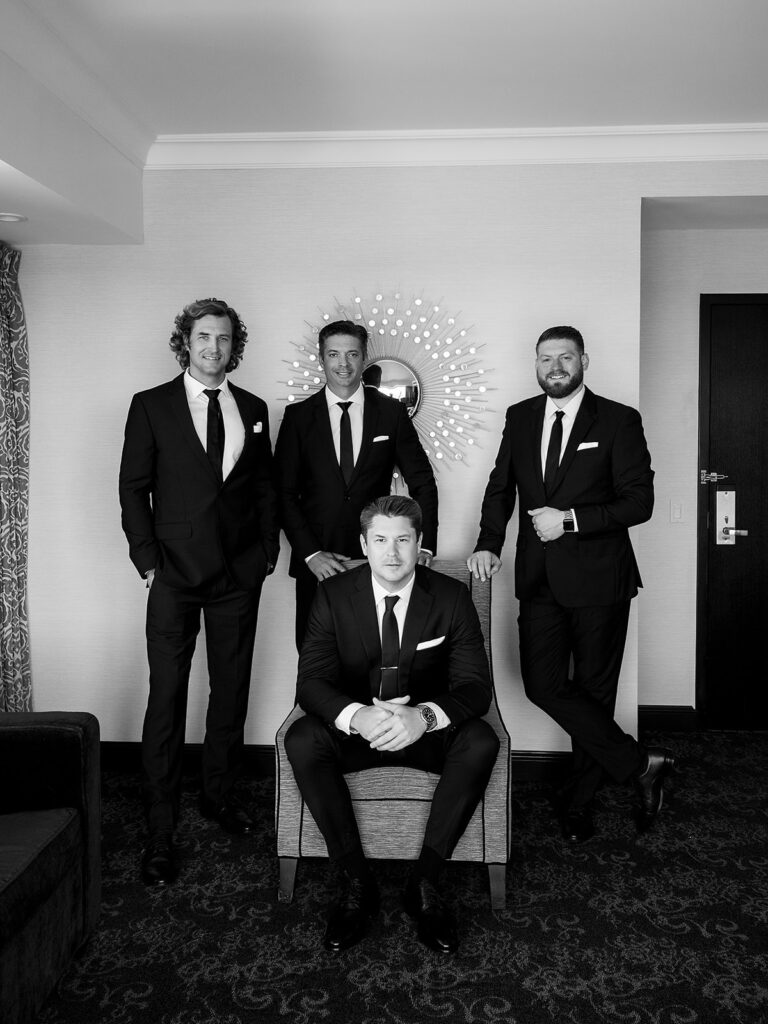 Indoor groom and groomsmen photos from a Amway Grand Plaza in Grand Rapids, Michigan