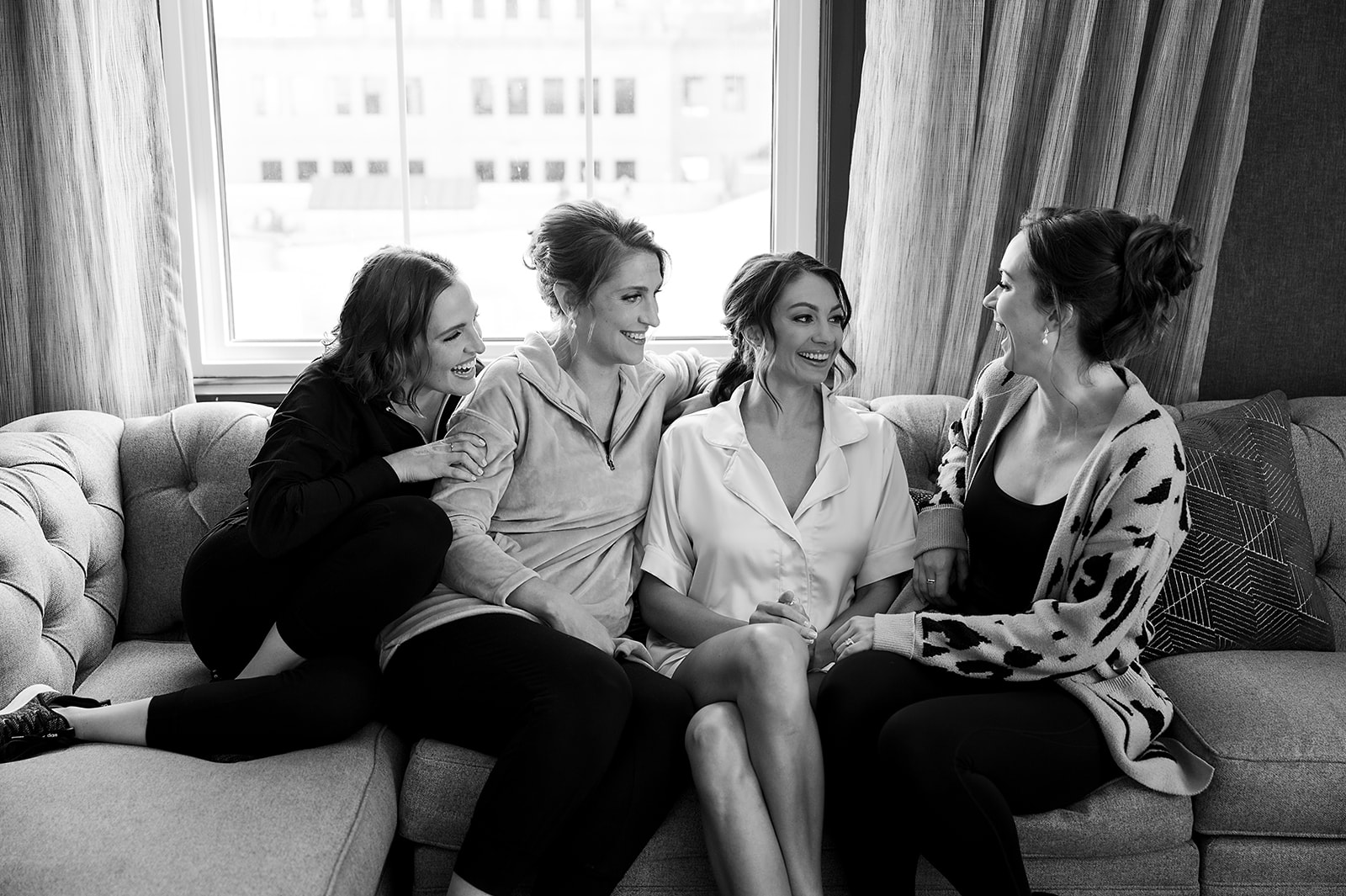 Bride sitting with her bridesmaids at Amway Grand Plaza