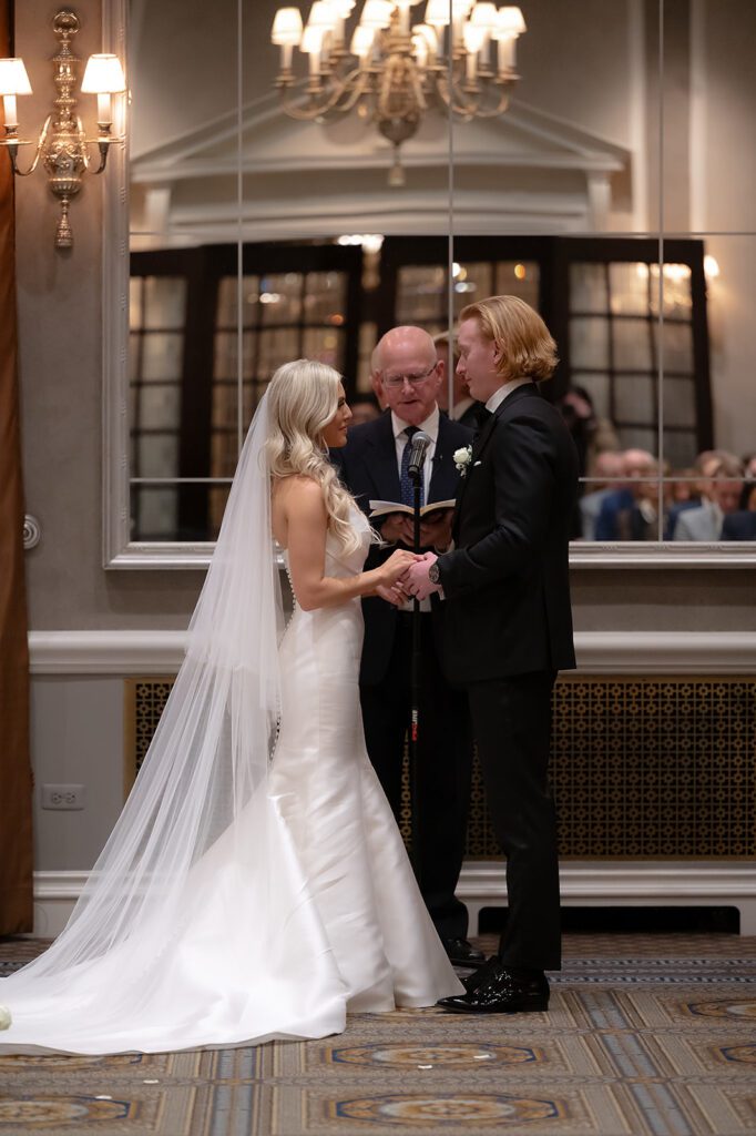 Bride and groom holding hands during their ceremony