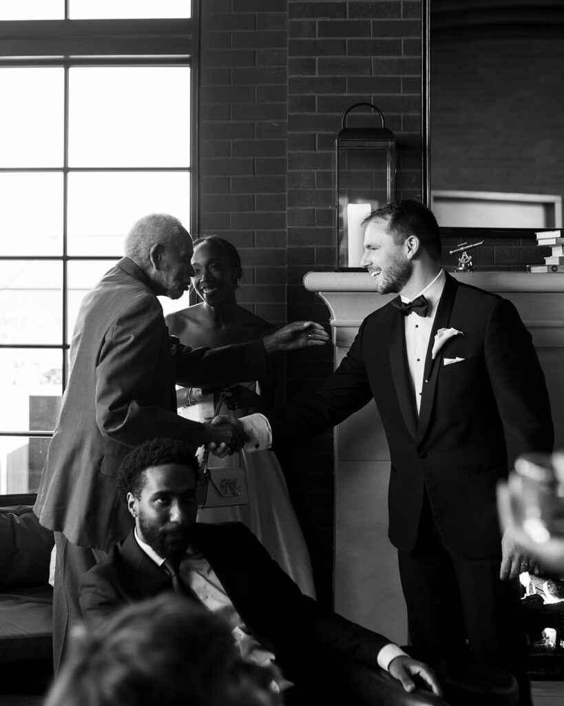 Groom mingling with guests during cocktail hour