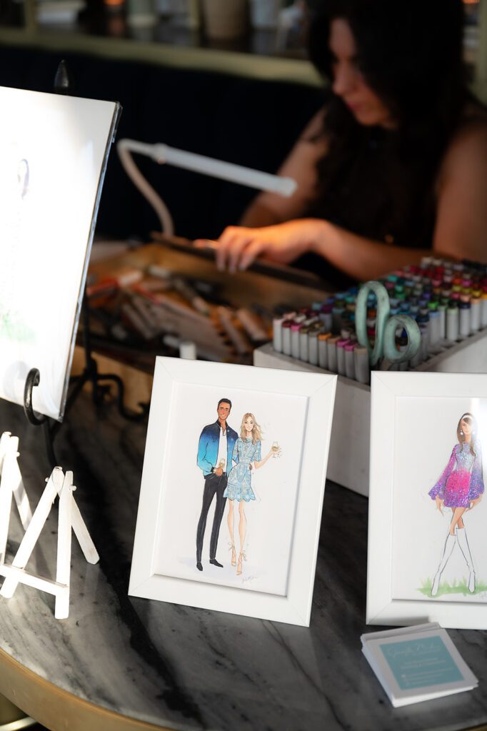 A live illustrator creates stylish sketches for guests at an MDRD Grand Plaza wedding, adding a personalized touch.