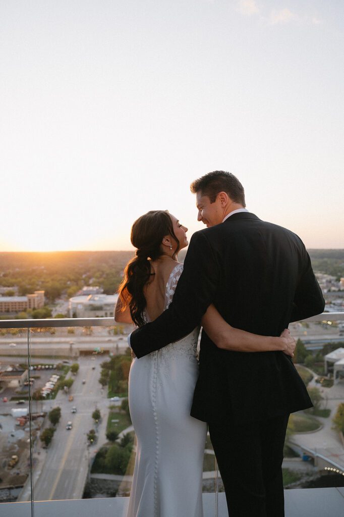 Bride and groom enjoying the views of Detroit during their Amway Grand Plaza wedding reception at MDRD
