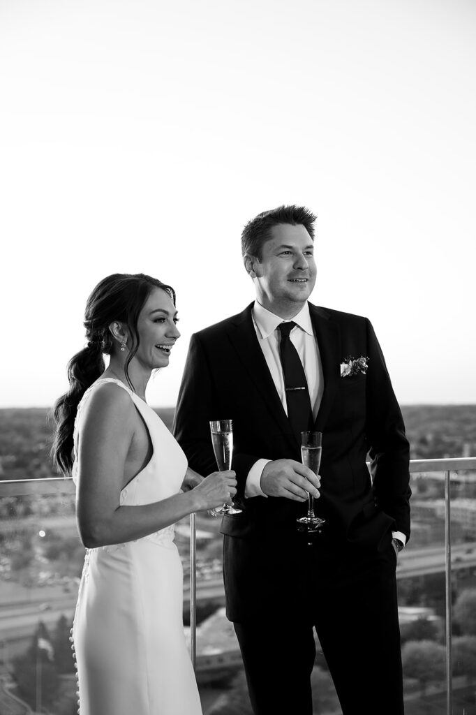 Bride and groom enjoying champagne during their Amway Grand Plaza wedding reception at MDRD