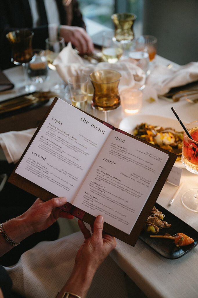 Guest reading the menu during a Amway Grand Plaza wedding reception at MDRD