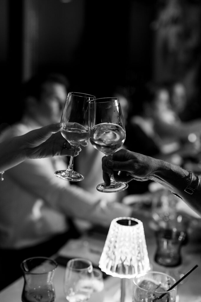 Guests toasting drinks during an Amway Grand Plaza wedding reception at MDRD