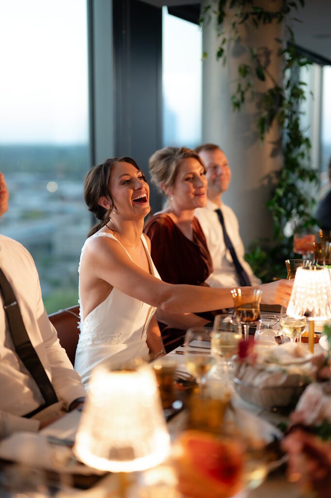 Bride laughing during her Amway Grand Plaza wedding reception at MDRD