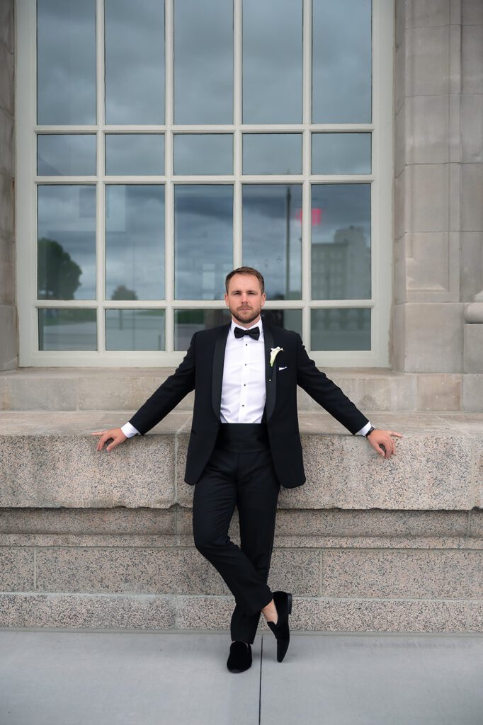 Groom posing at Michigan Central Train Station wedding portraits