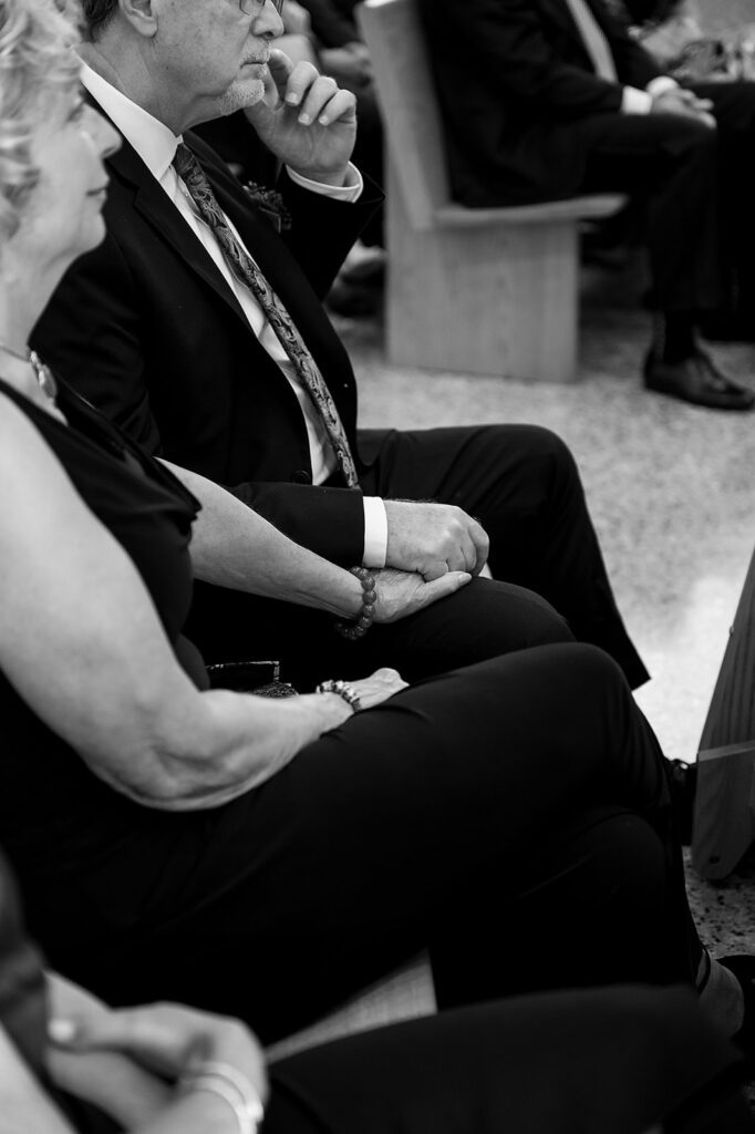 Candid wedding ceremony photo at Our Lady Seat of Wisdom Chapel on Aquinis College