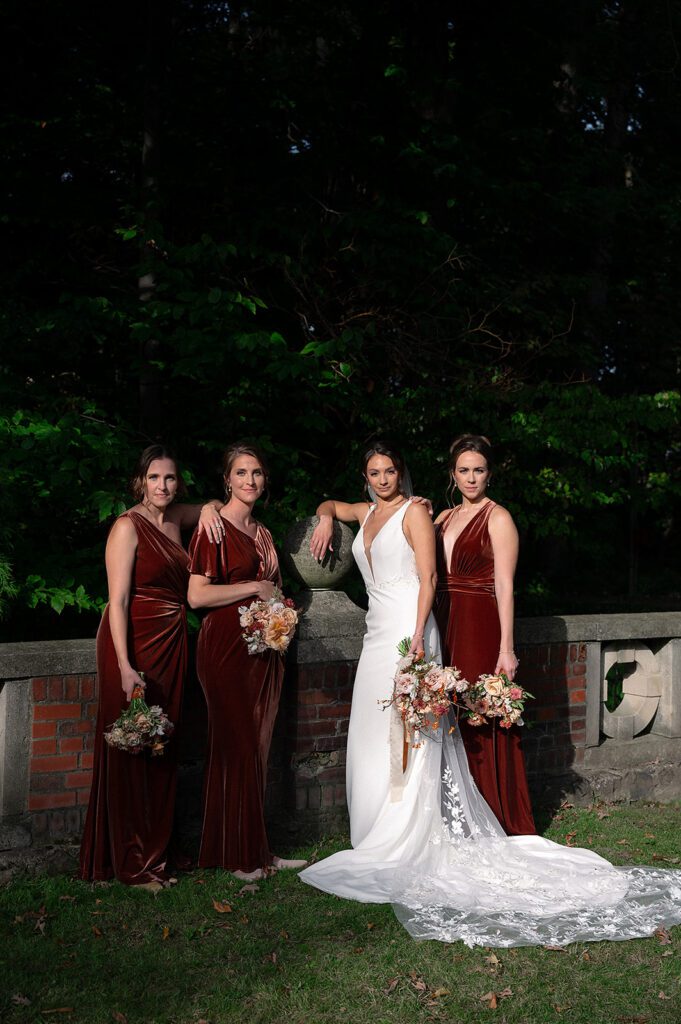 Outdoor fall bride and bridesmaids portraits at Holmdene Hall at Aquinas College
