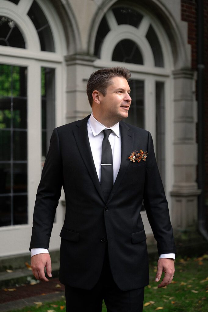 Outdoor grooms portrait at Holmdene Hall at Aquinas College