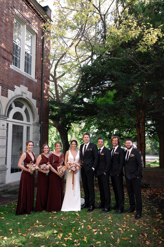 Outdoor fall wedding party photos at Holmdene Hall at Aquinas College